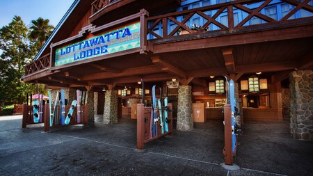 The outside of Lottawatta Lodge with skis and snowboards 