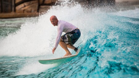 A man surfs on a wave