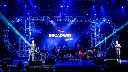 The Disney on Broadway sign lights up a stage filled with instruments at the Festival of the Arts