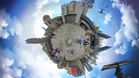 A special effects 360 degree aerial photo of a family at Star Wars Galaxy’s Edge with Tie Fighters flying overhead