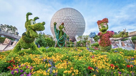 Topiaries of Pluto, Goof and Daisy Duck in front of Spaceship Earth at Epcot	
