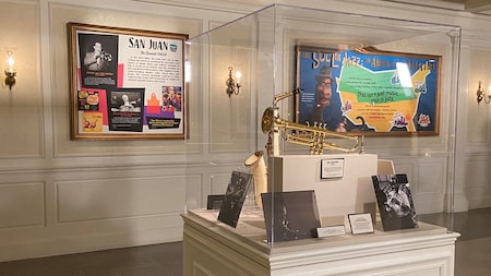 An exhibit in a gallery featuring a trumpet, saxophone, photos of musicians and 2 displays with the titles San Juan, and The Soul of Jazz, an American Adventure