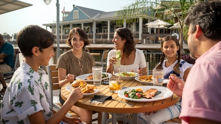 A family of 5 dining at an outdoor table at Disney Springs