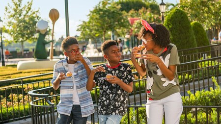 Three tweens enjoy each other's company and food from the World Showcase in Epcot