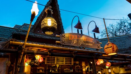 The exterior of The Tropical Hideaway lit at night