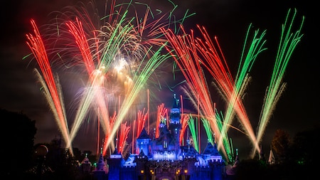Festive fireworks and lasers lighting up the sky above Sleeping Beauty Castle.