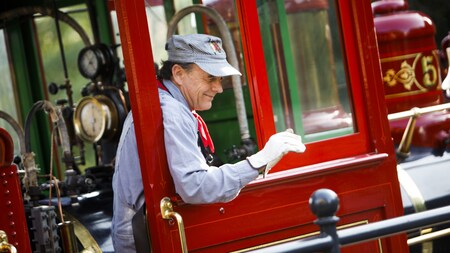 An engineer waves from aboard a train