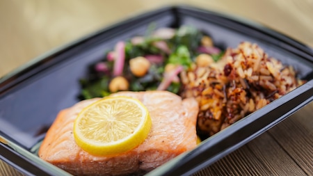 A fillet of salmon served with cooked vegetables