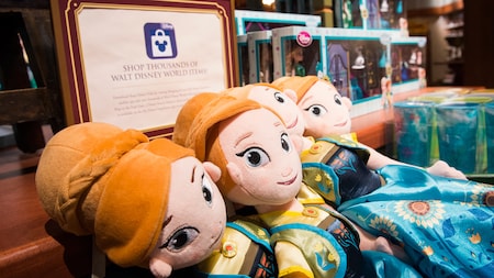 A store display featuring plush dolls of Anna as a young girl