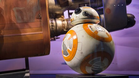 The Star Wars droid BB 8 is posed beside a replica space ship