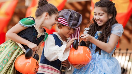 Kids dressed as Anna from ‘Frozen,’ Cinderella and a pirate smile after collecting allergy-free treats