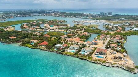 A verdant island in the Caribbean with waterfront houses