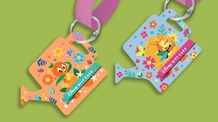 A pair of EPCOT International Flower & Garden Festival gift card lanyards shaped like watering cans