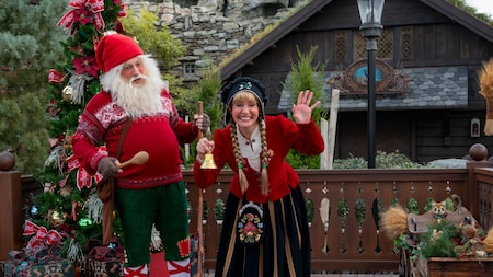 Barn Santa and Sigrid standing next to a Christmas tree in front of The Wandering Reindeer at Epcot