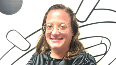 An artist with Disney named Kate Dykstra crossing her arms while smiling for a photo