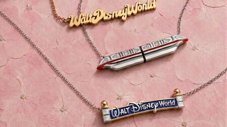 3 necklaces including a 'Walt Disney World' nameplate, a monorail pendant and a 'Walt Disney World' sign pendant