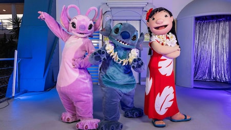 Angel, Stitch, and Lilo posing in front of Rockettower Plaza Stage