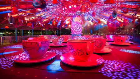 The Mad Tea Party attraction spinning with special lighting effects during the Mickey's Very Merry Christmas Party
