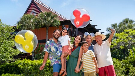 A multi generational family of 6 smiling for a photo at Disney's Polynesian Village Resort