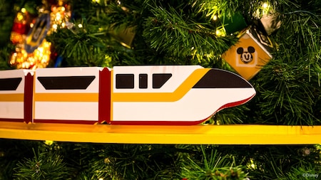 A Christmas tree with a replica of the Walt Disney World Monorail wrapped around it