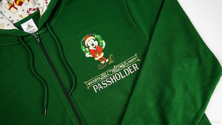 A Mickey’s Very Merry Christmas Party Passholder hoodie featuring Santa Mickey Mouse holding a wreath