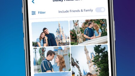 A mobile phone displaying photos of a couple at Magic Kingdom park in the Disney PhotoPass section of the My Disney Experience app