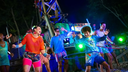 Guests engaged in Hula dancing during a DJ bash at Disney H2O Glow After Hours at Disney’s Typhoon Lagoon water park