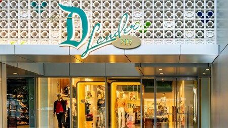 Exterior of Disney D Lander shop featuring a decorative sign and merchandise displays at the Downtown Disney District