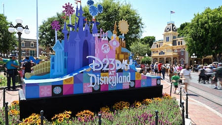 The D23 Day at Disneyland Resort decorative sign with castle sculptures 