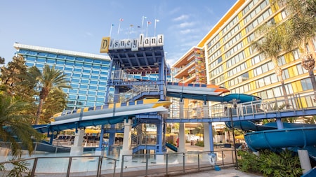 An outdoor pool and monorail themed water slide at the Disneyland Hotel