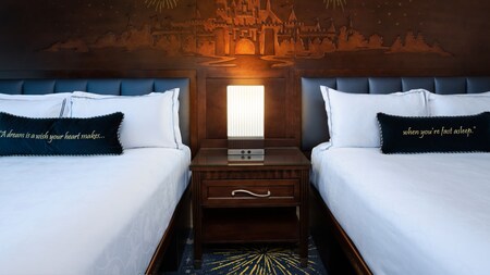 Beds with a Sleeping Beauty Castle illustration on the headboard at the Disneyland Hotel