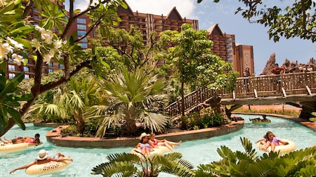 Several people on floats, drifting along the pool area's lazy river