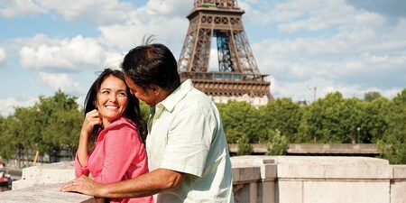 A couple gazes into each other’s eyes near the Eiffel Tower in Paris