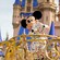 Mickey dressed in his confetti outfit waves to Guests on the cavalcade