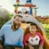 A man and a boy ride Slinky Dog Dash