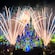A fireworks display over an illuminated Cinderella Castle