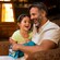 A family of four relax in the lobby of their Disney Resort hotel