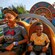 A mom wearing Mickey Mouse ears and her son scream while riding Slinky Dog Dash