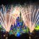 Fireworks burst over Cinderella Castle as lights cover it in a stained glass theme
