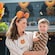 A mother holding her happy child amid the Halloween decorations at Magic Kingdom park