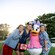 Three Guests posing with Daisy Duck in front of Disney’s Contemporary Resort