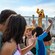 Pluto waving to guests from a bridge over the pool at Beach Club Resort