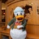 Donald Duck dressed in outdoor attire near an intricately carved wooden bench at Disney's Grand Californian Hotel & Spa