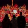 A silhouette of a family looking at lights during Holiday Time at the Disneyland Resort Guided Tour