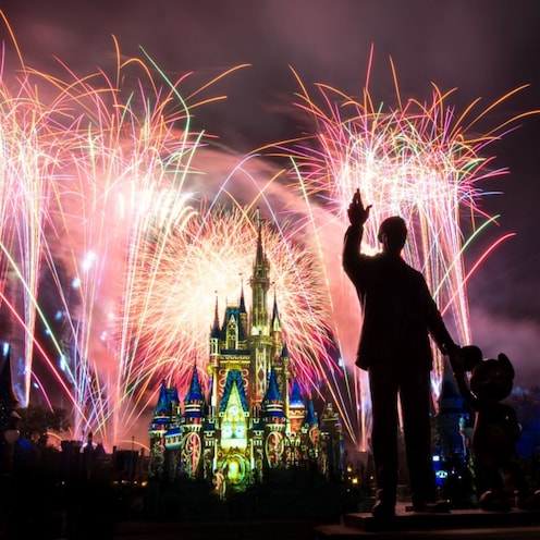 Fireworks burst in the sky over Cinderella Castle and the Partners statue of Walt Disney with Mickey Mouse at Magic Kingdom park