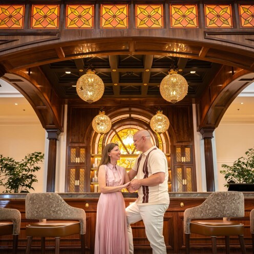 A couple holding hands during a portrait session at Disney's Grand Floridian Resort & Spa