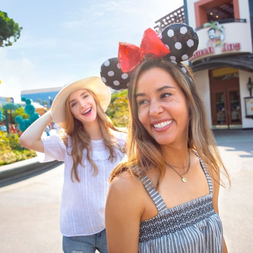 Two women walking through a courtyard in the Downtown Disney District