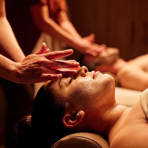 A couple enjoying a relaxing massage that includes special attention to the face, at Tenaya Stone Spa.