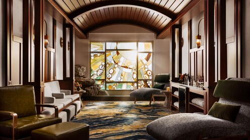 A hallway ending with a stained glass window in Disney's Grand Californian Hotel & Spa