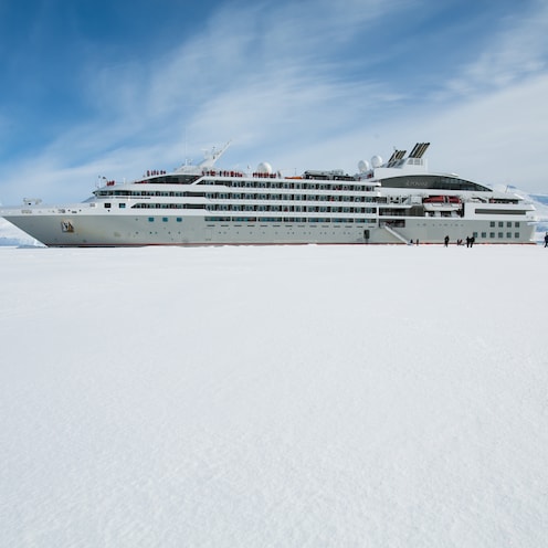 Cruise ship with disembarkation gangway to the snowy shore of Antarctica